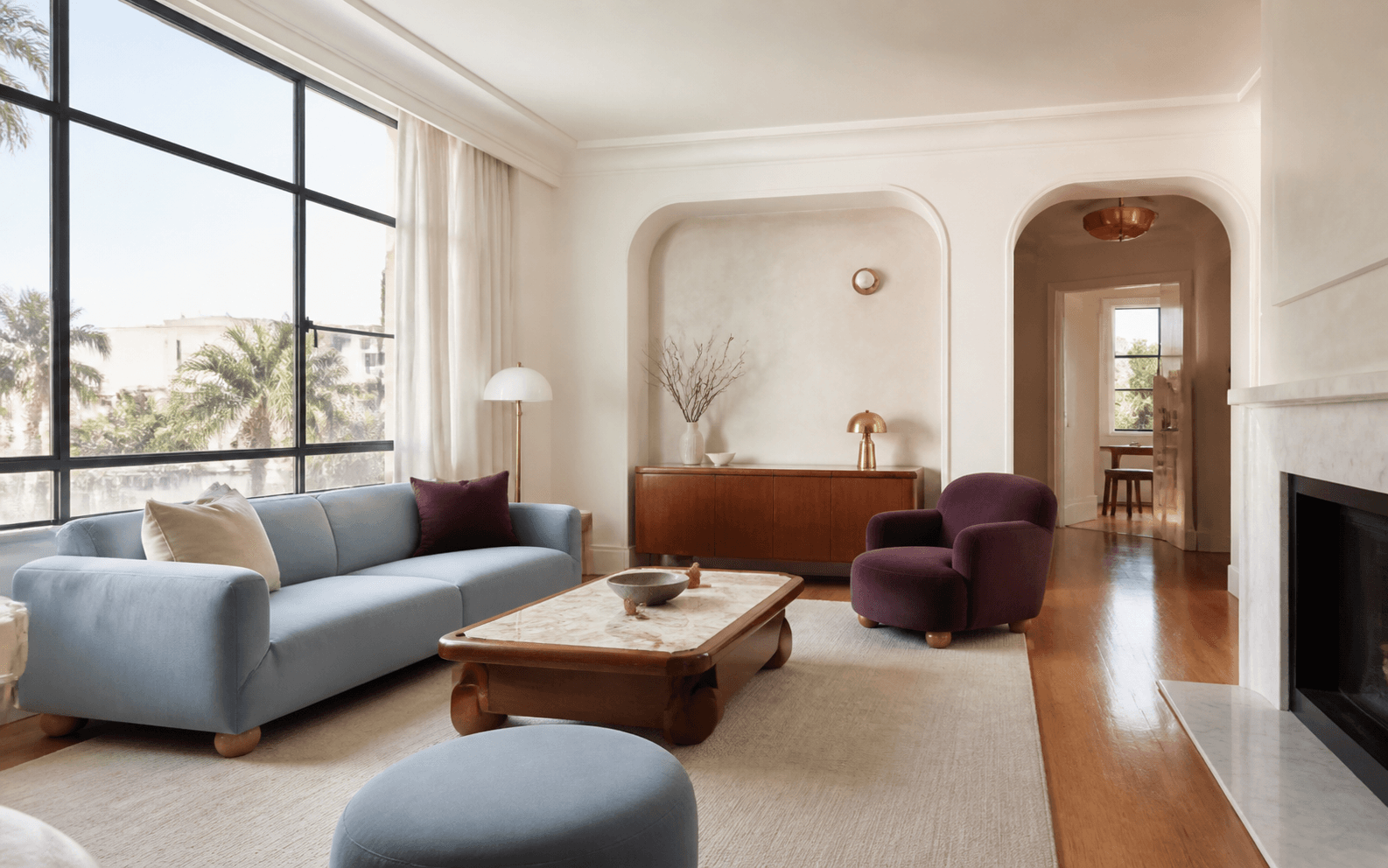 Light-filled Elwood apartment living room with curved plaster details and warm timber