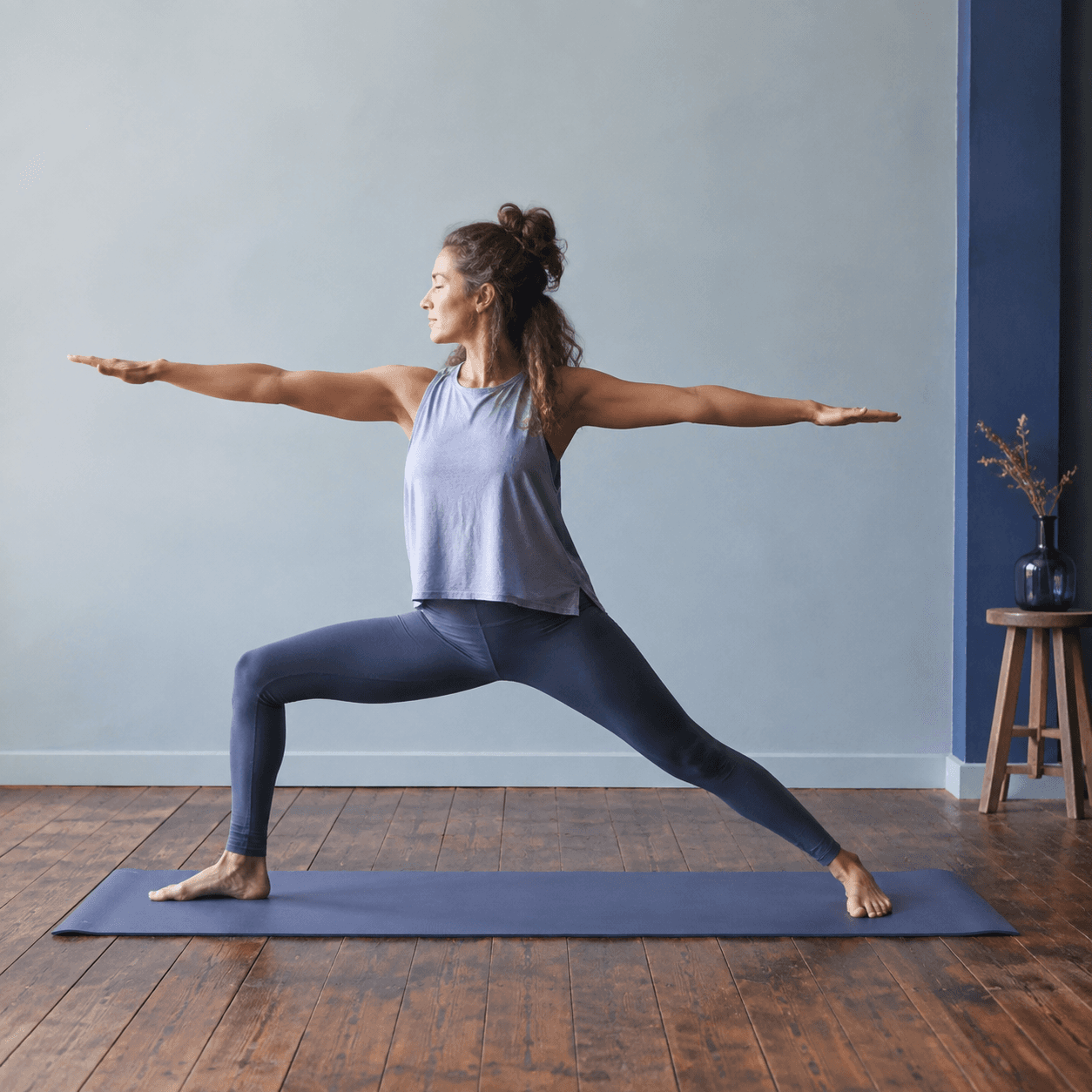 A student in a long-held standing shape during a Slow Flow class