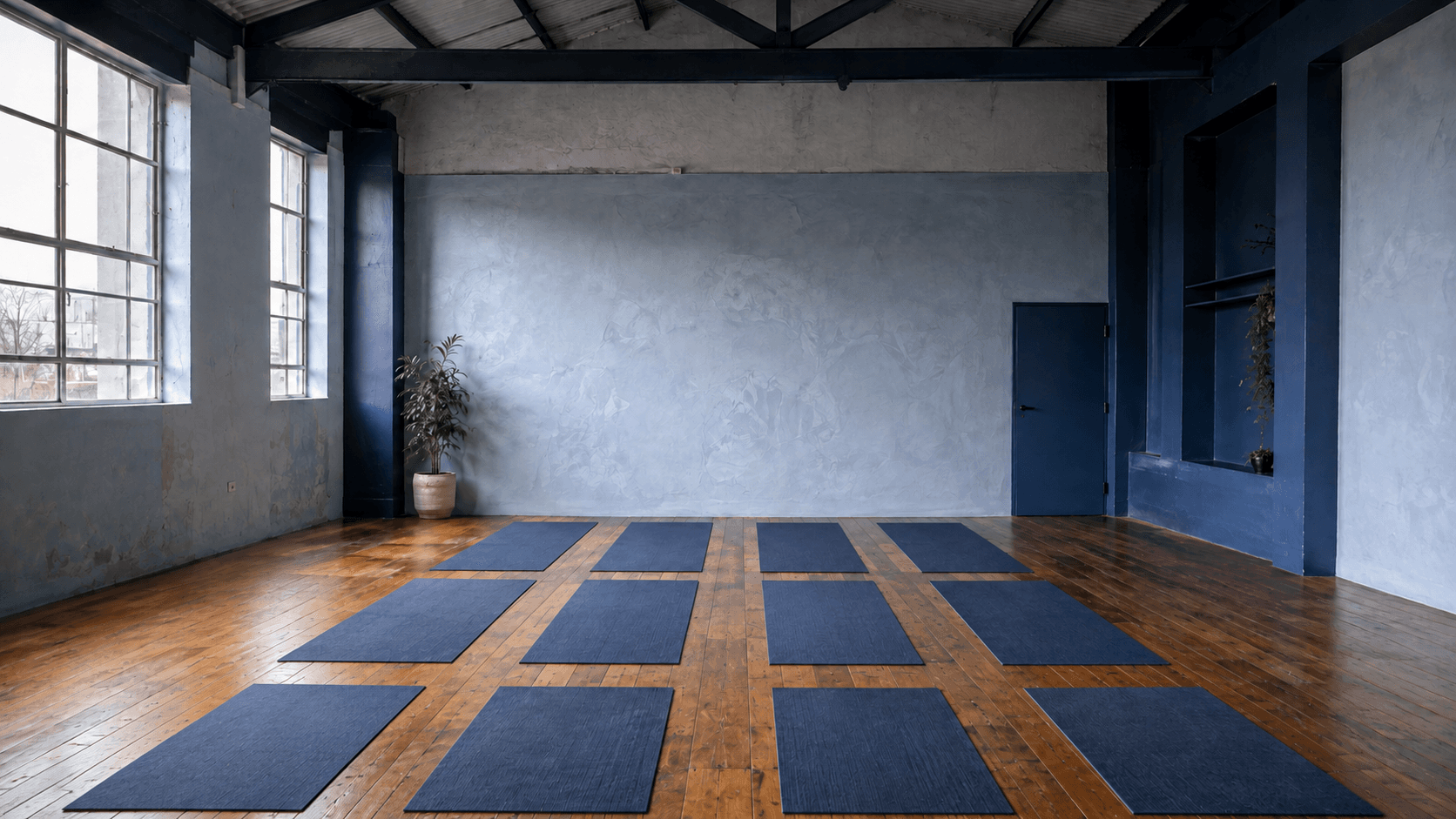 The empty Sundren practice room with hardwood floors and twelve mats laid out
